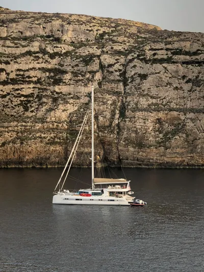 Adventure Yacht Photos Pics 2019 Squalt Marine CK 64 catamaran sailing near rocky cliffs.