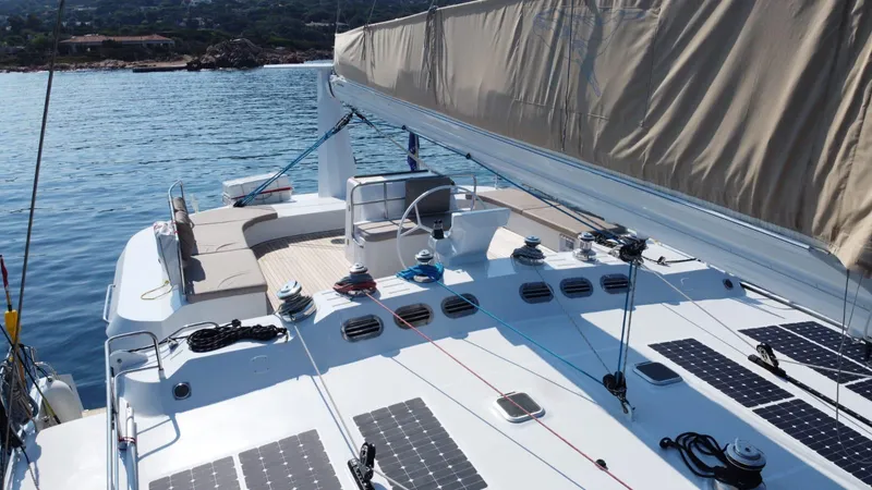 Adventure Yacht Photos Pics 2019 Squalt Marine CK 64 yacht with solar panels, anchored in serene waters.