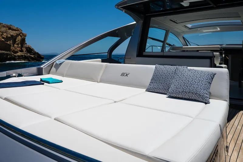 Polar Yacht Photos Pics 2023 Pershing 5x yacht with luxurious white seating and decorative pillows, set against a clear blue sky.