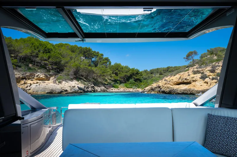 Polar Yacht Photos Pics Luxurious 2023 Pershing 5x yacht interior with stunning ocean view and lush greenery.