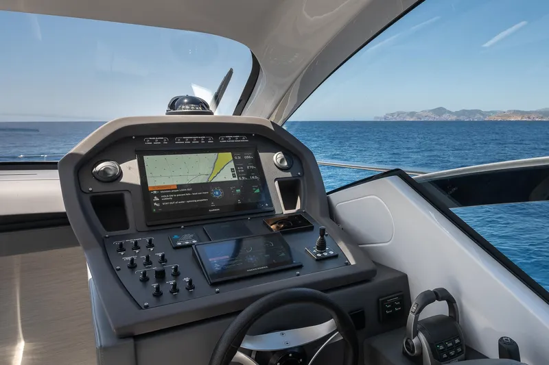 Polar Yacht Photos Pics 2023 Pershing 5x yacht cockpit with advanced navigation system, overlooking the ocean.