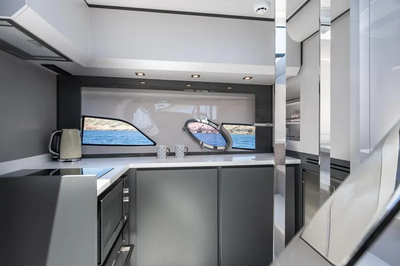 Polar Yacht Photos Pics Modern kitchen interior of 2023 Pershing 5x yacht with sleek design and ocean view.