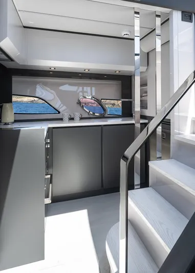 Polar Yacht Photos Pics Modern interior of 2023 Pershing 5x yacht with sleek kitchen and staircase.
