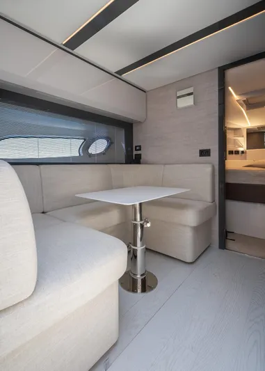 Polar Yacht Photos Pics Luxurious interior of 2023 Pershing 5x yacht with modern seating and table.