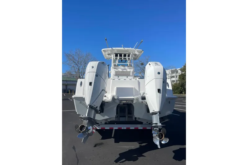  Yacht Photos Pics 2024 Caymas 34 CT boat with dual outboard engines, viewed from the rear.