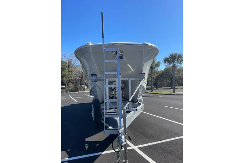  Yacht Photos Pics 2024 Caymas 34 CT boat on trailer in parking lot, clear sky background.