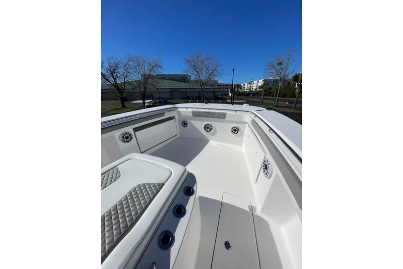  Yacht Photos Pics 2024 Caymas 34 CT boat interior with seating and speakers, under clear blue sky.
