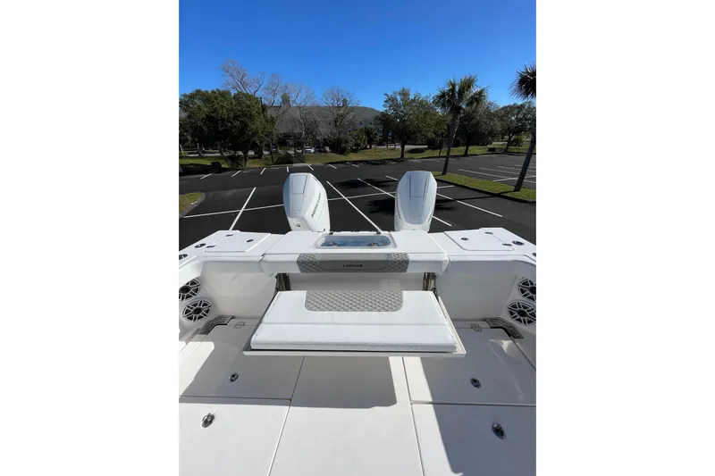  Yacht Photos Pics 2024 Caymas 34 CT boat with dual engines, parked in a sunny lot.