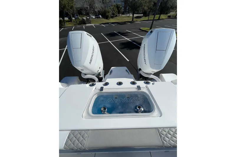  Yacht Photos Pics 2024 Caymas 34 CT boat with dual Mercury outboard engines in a parking lot.