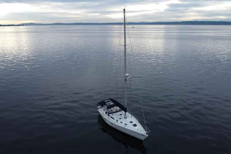 Moana Yacht Photos Pics Sailboat Catalina 42 MkII 1998 on calm water under cloudy sky.