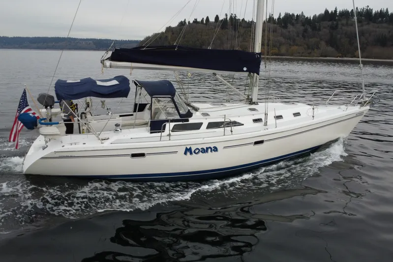 Moana Yacht Photos Pics 1998 Catalina 42 MkII sailboat cruising on calm waters with American flag.