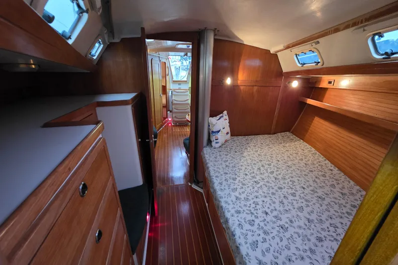 Moana Yacht Photos Pics Cozy interior of 1998 Catalina 42 MkII sailboat with wooden cabinetry and comfortable sleeping area.