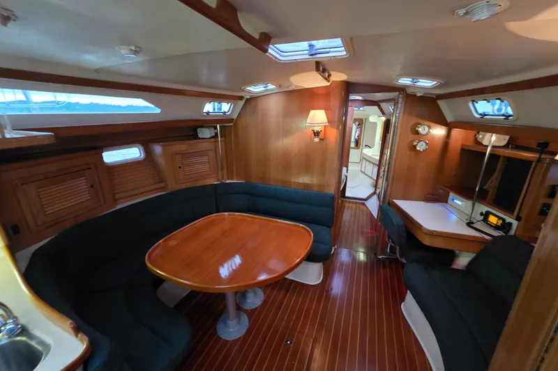 Moana Yacht Photos Pics Interior of 1998 Catalina 42 MkII sailboat with wooden furnishings and cozy seating area.