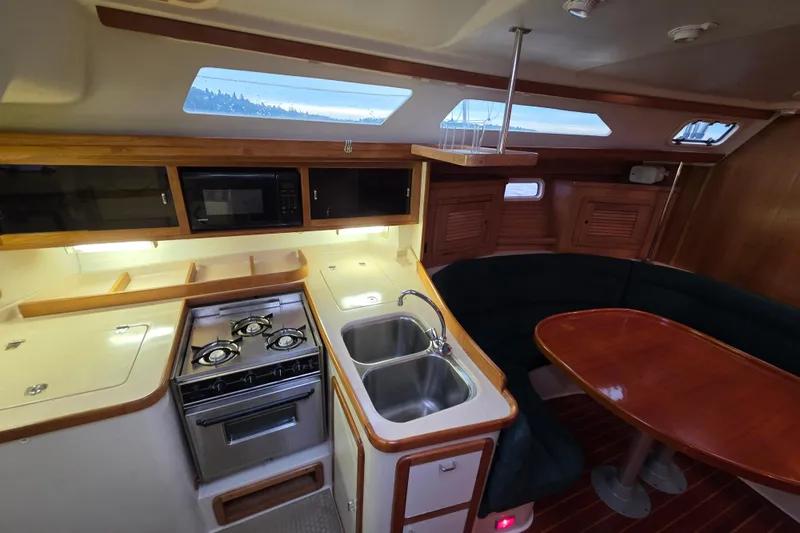 Moana Yacht Photos Pics Interior of a 1998 Catalina 42 MkII yacht with kitchen and dining area.