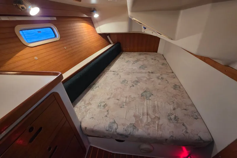 Moana Yacht Photos Pics Cozy cabin interior of 1998 Catalina 42 MkII sailboat with wooden accents and comfortable bedding.