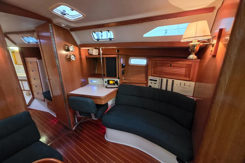 Moana Yacht Photos Pics Interior of a 1998 Catalina 42 MkII sailboat with wood paneling and cozy seating.