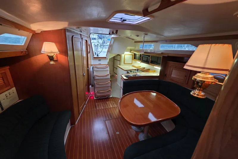 Moana Yacht Photos Pics Interior of 1998 Catalina 42 MkII yacht with cozy seating and elegant wooden finishes.