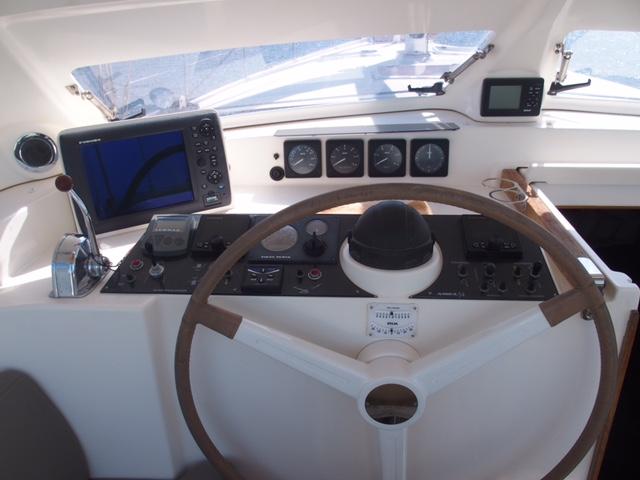 Cockpit of 2010 Amel 54 yacht with navigation instruments and steering wheel.