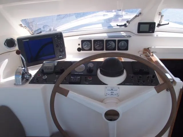 Cockpit of 2010 Amel 54 yacht with navigation instruments and steering wheel.