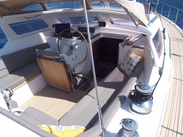 Luxurious 2010 Amel 54 yacht cockpit with steering wheel, seating, and navigation equipment.