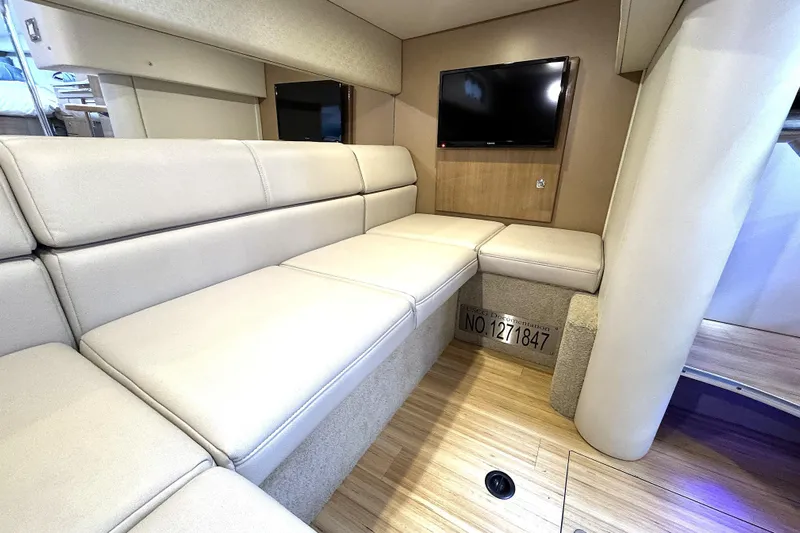 Blue Skye Yacht Photos Pics Interior of 2016 Formula 34 Performance Cruiser with beige seating and mounted TV.