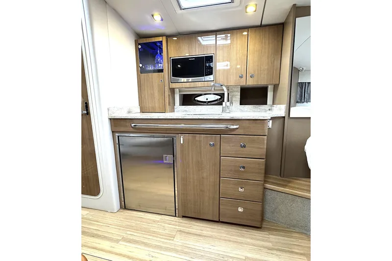 Blue Skye Yacht Photos Pics 2016 Formula 34 Performance Cruiser interior kitchen with wood cabinets and modern appliances.