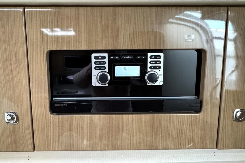 Blue Skye Yacht Photos Pics Built-in stereo system in 2016 Formula 34 Performance Cruiser, featuring wood paneling and Samsung components.