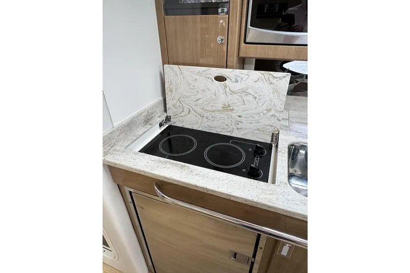 Blue Skye Yacht Photos Pics 2016 Formula 34 Performance Cruiser kitchen with electric stove and marble countertop.