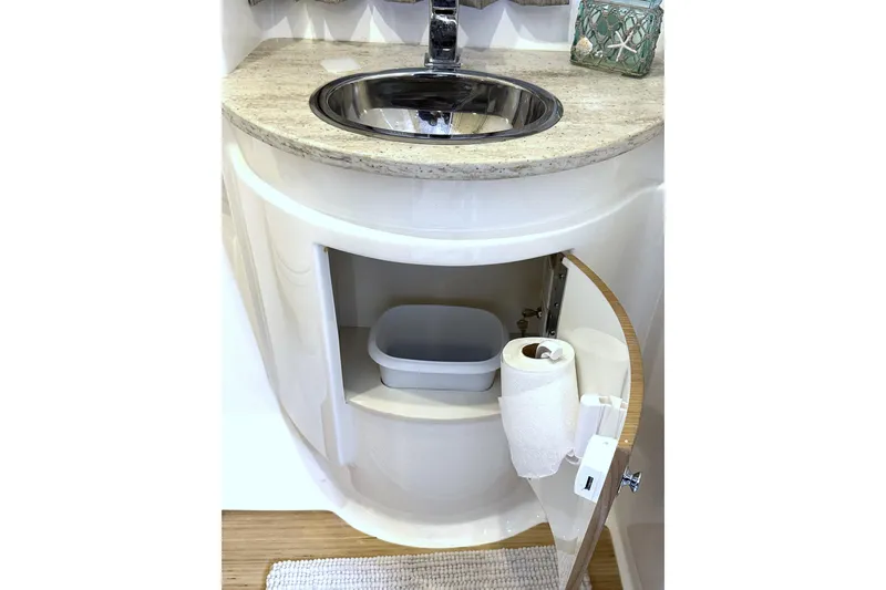 Blue Skye Yacht Photos Pics 2016 Formula 34 Performance Cruiser bathroom sink with storage cabinet open.