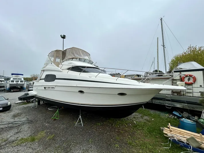  Yacht Photos Pics 2001 Silverton 410 Sport Bridge yacht on land, overcast sky, marina setting.