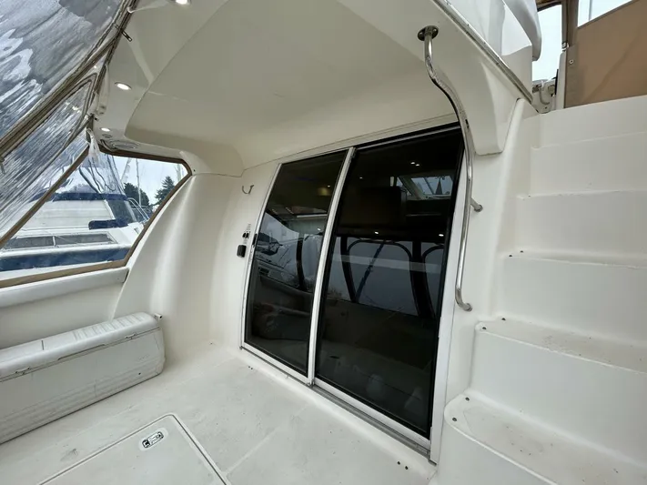  Yacht Photos Pics 2001 Silverton 410 Sport Bridge interior with sliding glass doors and staircase.