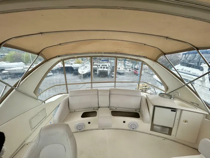  Yacht Photos Pics 2001 Silverton 410 Sport Bridge interior with seating and helm, showcasing spacious design.