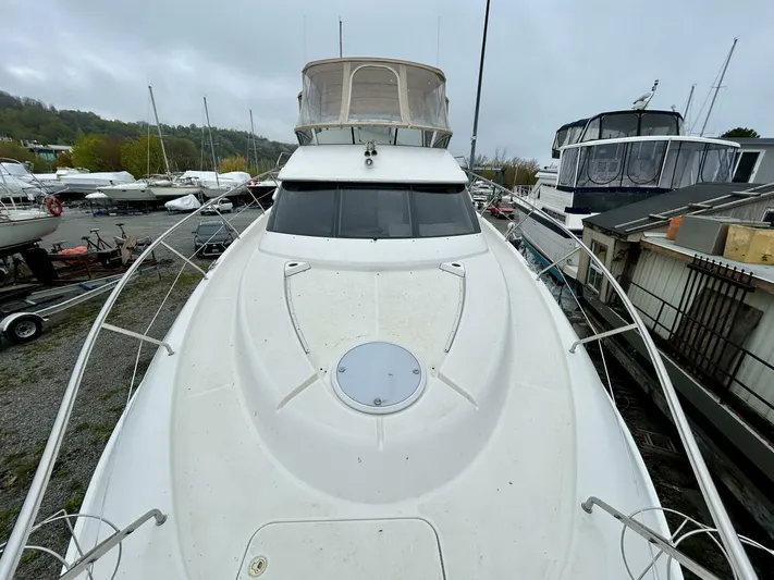  Yacht Photos Pics 2001 Silverton 410 Sport Bridge yacht docked in a marina.