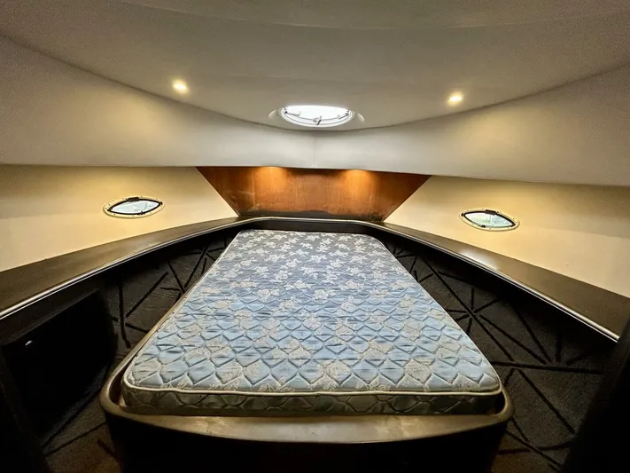  Yacht Photos Pics Luxurious cabin interior of 2001 Silverton 410 Sport Bridge with cozy bed and ambient lighting.