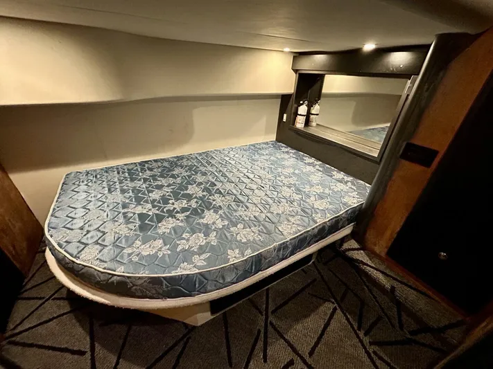  Yacht Photos Pics 2001 Silverton 410 Sport Bridge cabin with a blue floral mattress and modern decor.