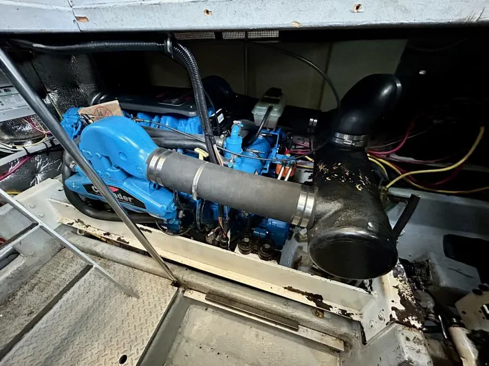  Yacht Photos Pics Engine compartment of a 2001 Silverton 410 Sport Bridge, showcasing a blue marine engine.