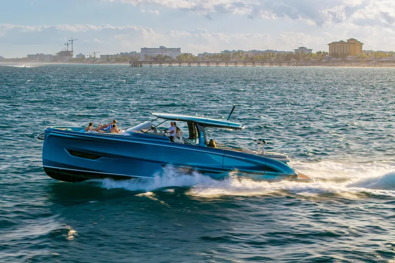  Yacht Photos Pics 2024 Solaris Power 52 Open yacht cruising on ocean near city skyline.