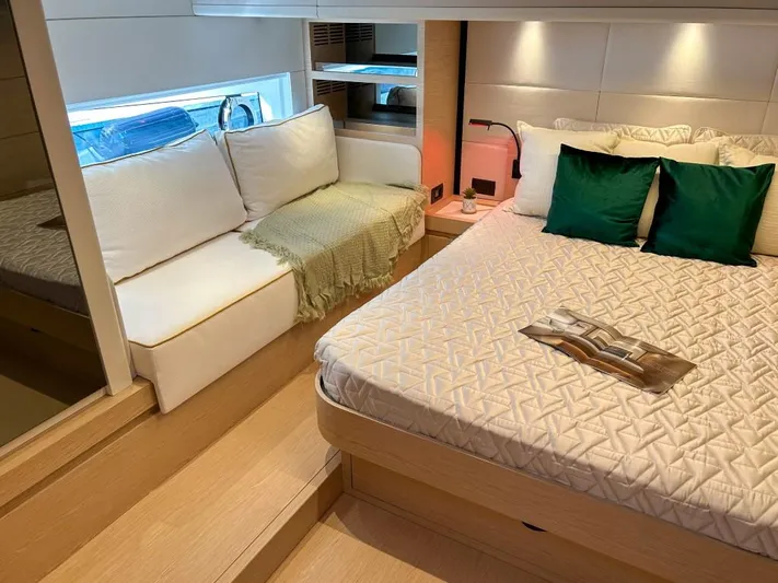  Yacht Photos Pics Luxurious bedroom interior of 2024 Solaris Power 52 Open yacht with cozy seating area.