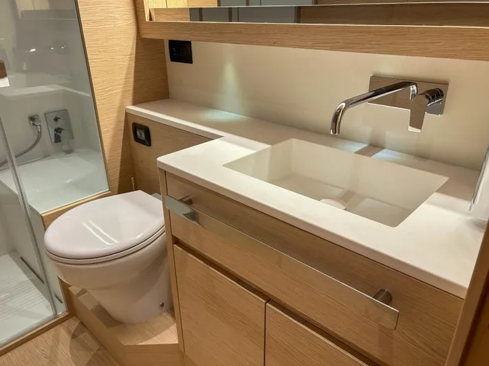  Yacht Photos Pics Modern bathroom in 2024 Solaris Power 52 Open yacht with sleek fixtures and wooden cabinetry.