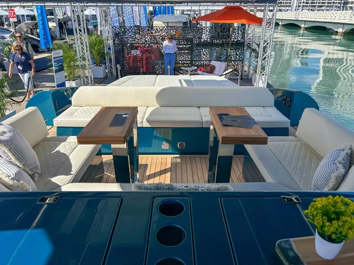  Yacht Photos Pics 2024 Solaris Power 52 Open luxury yacht interior with seating and tables at a marina.