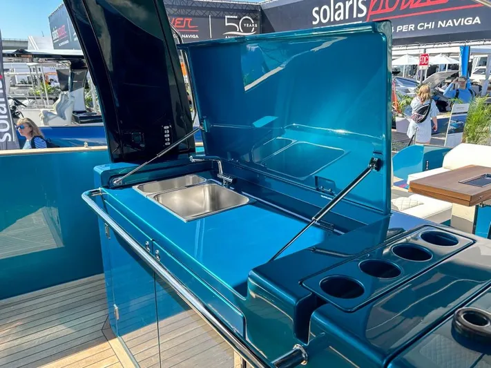  Yacht Photos Pics 2024 Solaris Power 52 Open yacht with sleek blue outdoor kitchen and sink.
