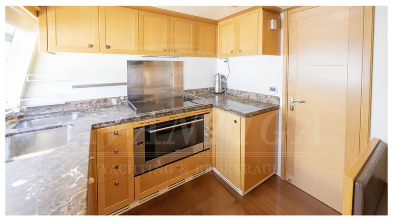  Yacht Photos Pics Luxurious kitchen in 2008 Ferretti Yachts Customline Navetta 26 with modern appliances.