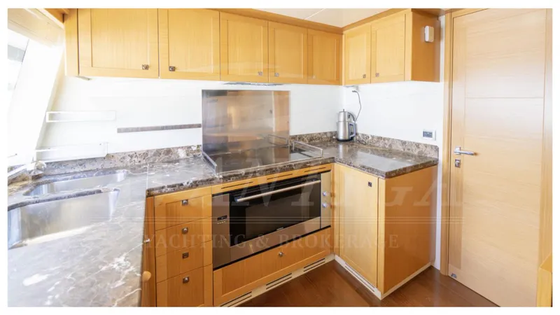  Yacht Photos Pics Luxurious kitchen in 2008 Ferretti Yachts Customline Navetta 26 with modern appliances.