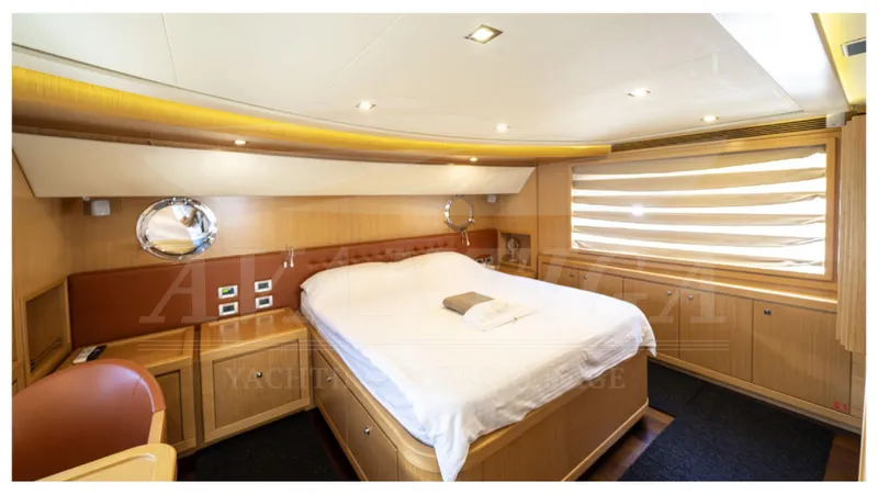  Yacht Photos Pics Luxurious bedroom in 2008 Ferretti Yachts Customline Navetta 26, featuring elegant wood finishes.