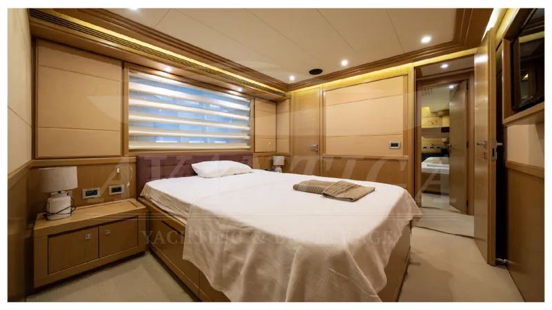  Yacht Photos Pics Luxurious bedroom interior of 2008 Ferretti Yachts Customline Navetta 26, featuring elegant wood paneling.