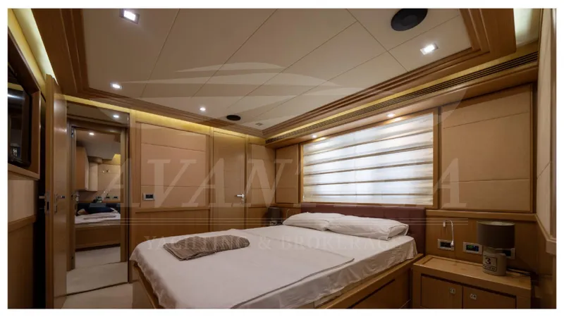  Yacht Photos Pics Luxurious bedroom interior of 2008 Ferretti Yachts Customline Navetta 26, featuring elegant wood paneling.
