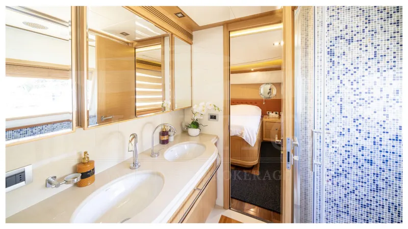  Yacht Photos Pics Luxurious bathroom interior of 2008 Ferretti Yachts Customline Navetta 26 with double sinks and mosaic shower.
