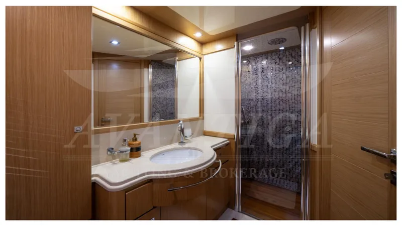  Yacht Photos Pics Luxurious bathroom in 2008 Ferretti Yachts Customline Navetta 26, featuring modern fixtures and wood accents.