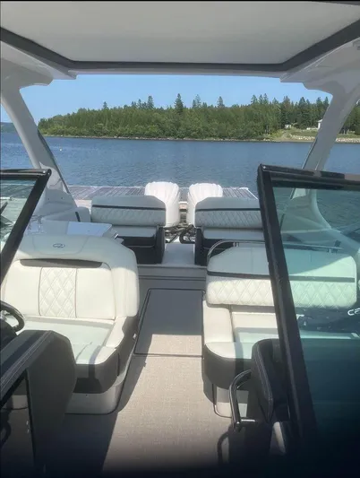  Yacht Photos Pics 2024 Regal 29 OBX boat interior with luxurious seating, overlooking a serene lake view.