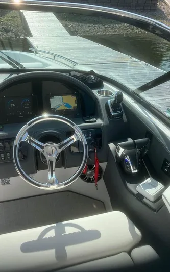  Yacht Photos Pics 2024 Regal 29 OBX boat cockpit with steering wheel and navigation system.